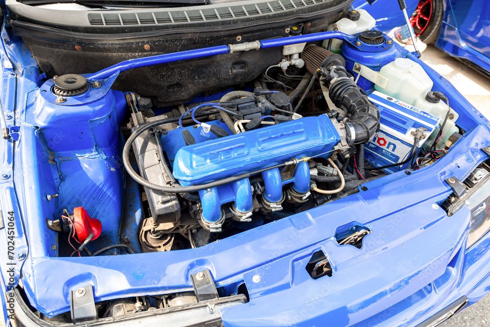 Engine under the hood of a tuning Lada 2110 vehicle with a variety of ...