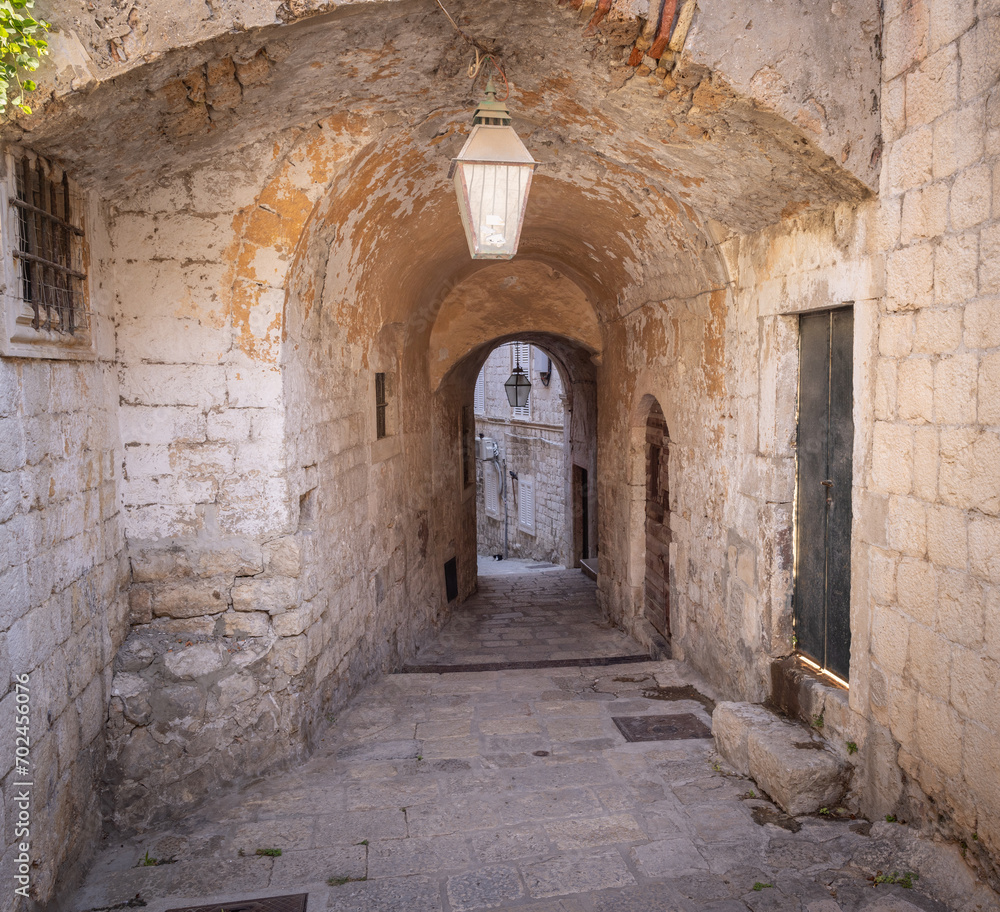 The medieval city of Dubrovnik, Dalmatia, Croatia. Arch in a narrow street.