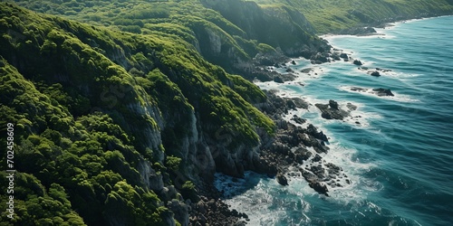 Island with an active volcano, covered with vegetation and a large ocean, aerial view.
