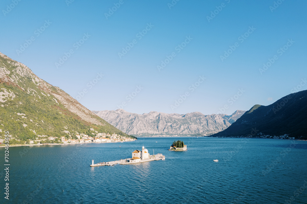 Small islands in the Bay of Kotor surrounded by a mountain range. Montenegro. Drone