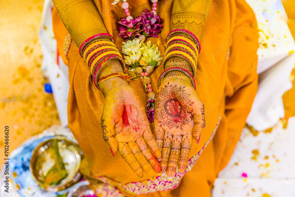 Indian Hindu pre wedding yellow turmeric haldi ceremony hands close up