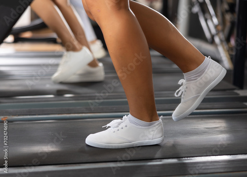 Woman's legs running on treadmill in gymworking out on treadmill © JackF