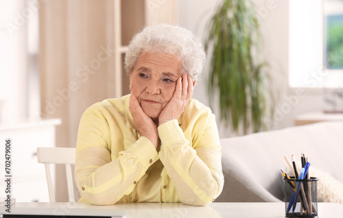 Senior woman sitting at home