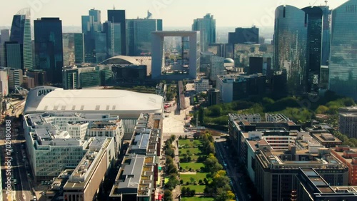 Establishing Aerial view of Business District La Defense in Paris Downtown with Skyscrapers, Office Buildings and Grande Arche. Modern Cityscape of Capital of France. 4K drone tilt down shot