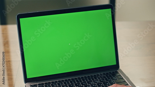 Boss using green screen laptop in office. Business man working mockup computer