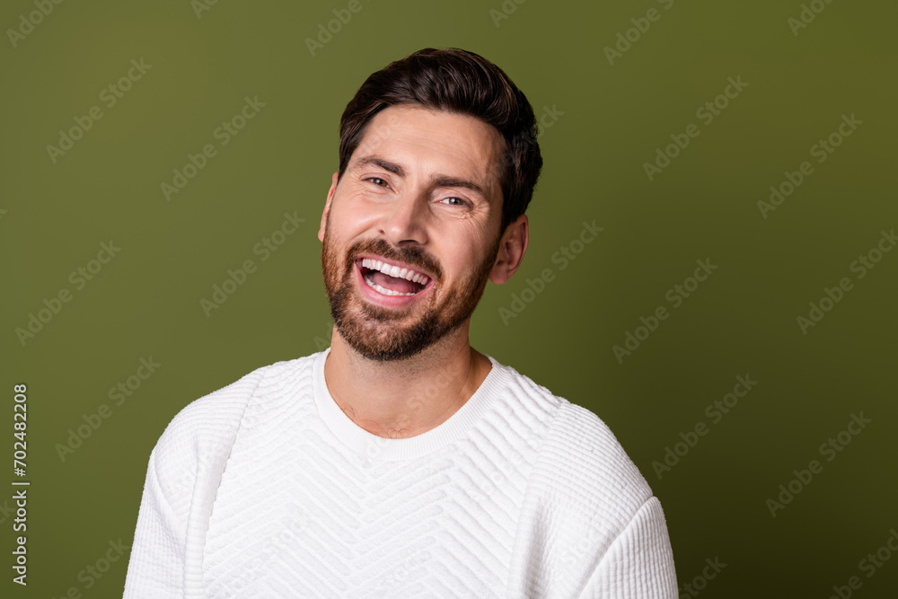 Photo of cheerful good mood guy dressed white trendy clothes laughing isolated on khaki color background Photo of cheerful good mood guy dressed white trendy clothes laughing isolated on khaki color background