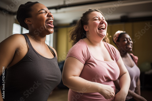 Portrait of happy multiethnic overweight women laughing while exercising together in a fitness studio