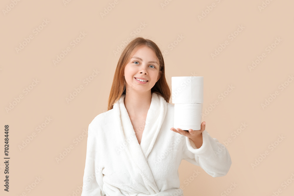 Young woman in bathrobe with toilet paper rolls on color background - obrazy, fototapety, plakaty 