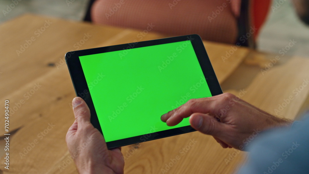 Man finger swiping greenscreen tablet office. Close up specialist scrolling tab