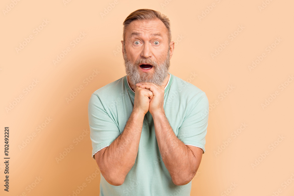 Photo of shocked anxious embarrassed man open mouth impressed reaction bad news isolated on beige color background Photo of shocked anxious embarrassed man open mouth impressed reaction bad news isolated on beige color background