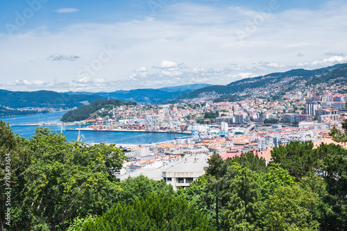 The view from the hill in Parque Monte del Castro, park located on a hill in Vigo, the biggest city in Galicia Region, in the North of Spain. View of the sea, houses and trees, selective focus © Liliya Trott