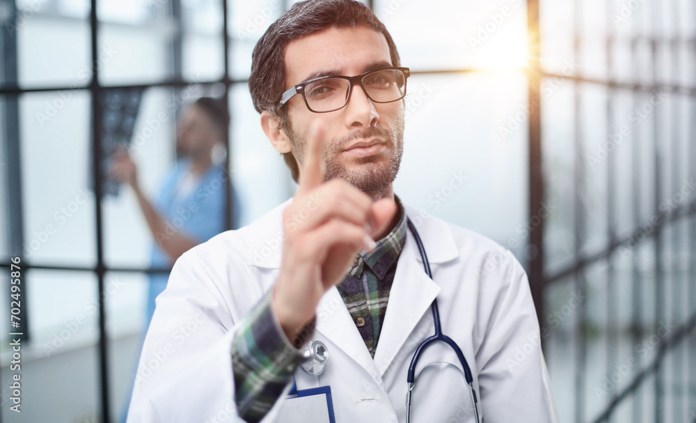attentive doctor in white coat pointing his finger at you