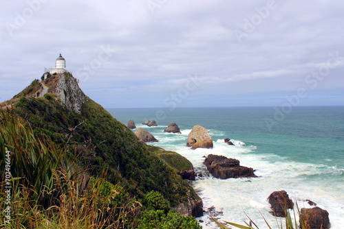 new zealand view into the sea with lightshouse photo