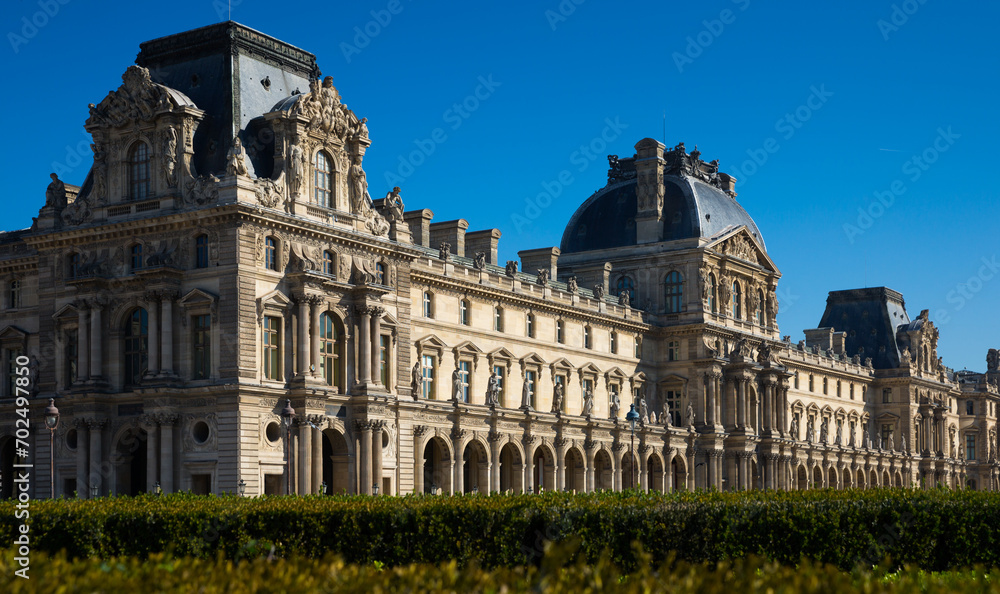 View of impressive building of Louvre Palace on sunny autumn day..
