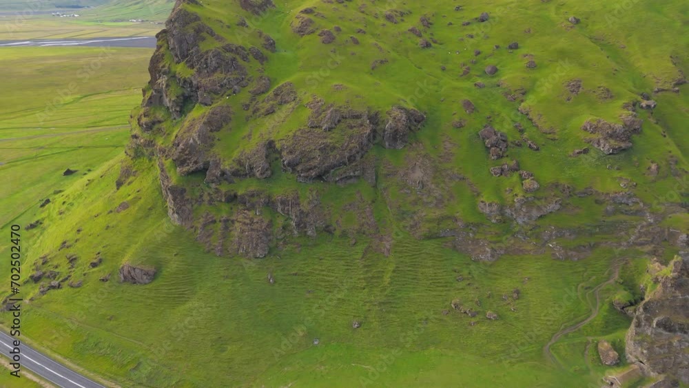 Stunning aerial view of hills and fields all covered with green grass, asphalt road going through icelandic picturesque corners with lonely houses on the side. High quality 4k footage Stunning aerial view of hills and fields all covered with green grass, asphalt road going through icelandic picturesque corners with lonely houses on the side. High quality 4k footage