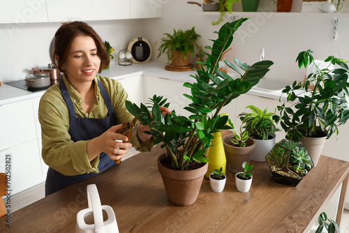 Female gardener cutting off...