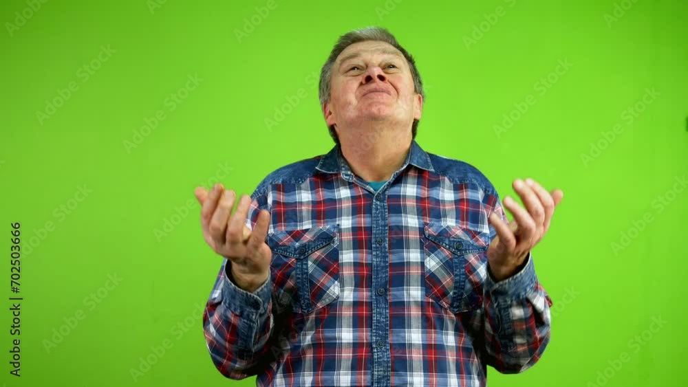 Senior man thinks, taps his forehead, finds simple solution and shows thumbs up. Senior man thinks, taps his forehead, finds simple solution and shows thumbs up.