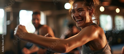 Cheerful woman trains with man in self-defense class in gym. photo