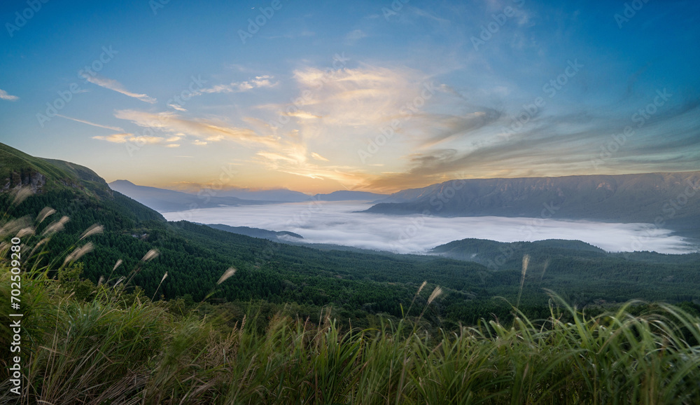 Sunrise over large valley above the clouds