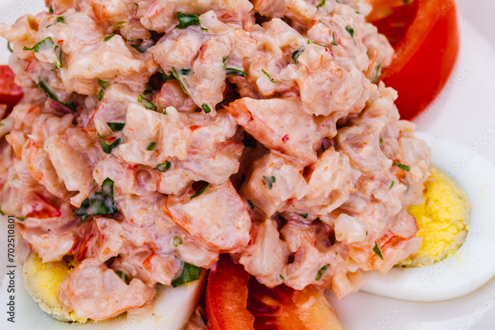 Lobster salad with egg and tomato on white plate. Lobster salad with egg and tomato on white plate.