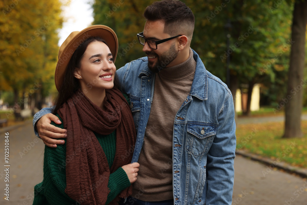 Fototapeta premium Happy young couple spending time together in autumn park