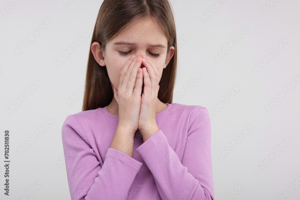 Sick girl coughing on light background. Cold symptoms Sick girl coughing on light background. Cold symptoms