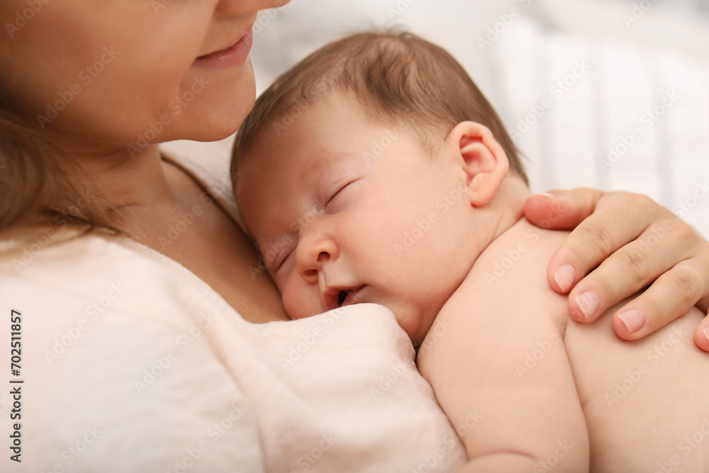 Mother holding her cute newborn baby indoors Mother holding her cute newborn baby indoors