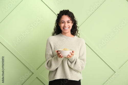 Smiling young woman holding...