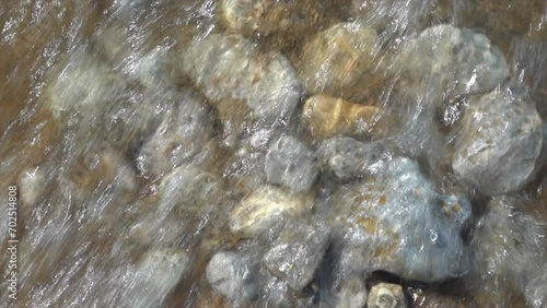 Cinematic shoreline Lake Michigan Petosky Stone rocky beachside peaceful dramatic state park Harbor Springs Mackinaw Island Up North summer daytime bright afternoon calm peaceful slow pan upward photo