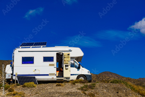 Caravan with tilt solar panel on roof.