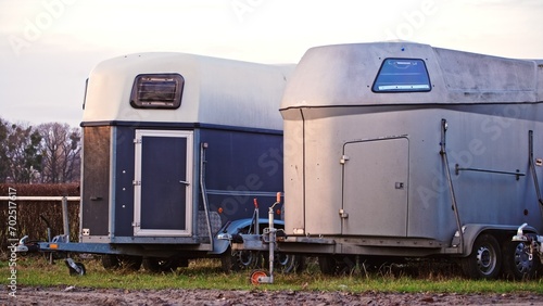 Slika na platnu Horse Trailers Parked on Open Field Horse Race Track during Tournament Season