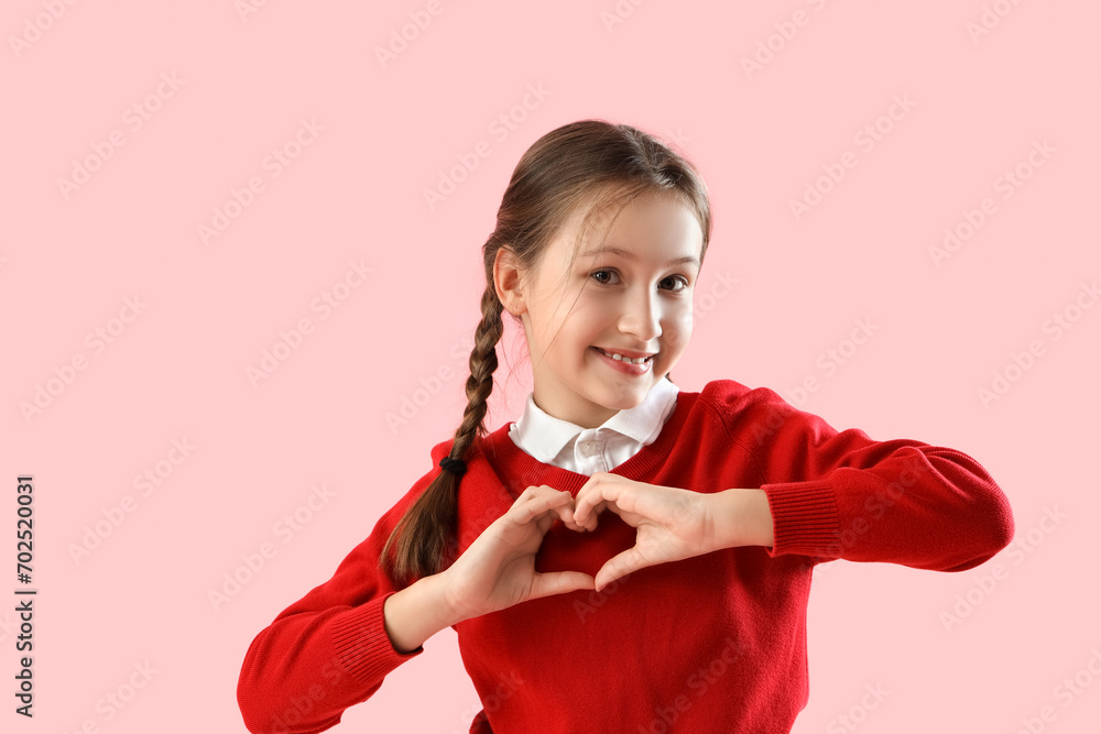 Cute little girl making heart with hands on pink background. Valentine's day celebration Cute little girl making heart with hands on pink background. Valentine's day celebration