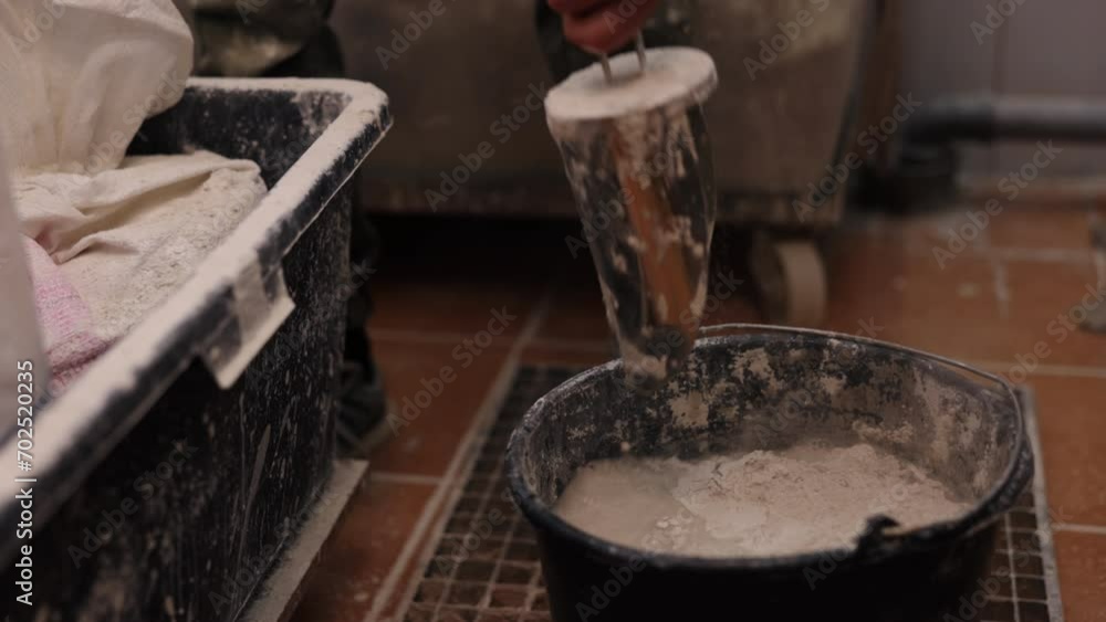 Model preparation, Water combining, Model making. Preparing model made of gypsum, man introduces gypsum into water. Model preparation, Water combining, Model making. Preparing model made of gypsum, man introduces gypsum into water.