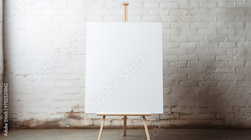 A blank white canvas positioned on an easel in a room with white brick walls, ready for an artist's stroke.