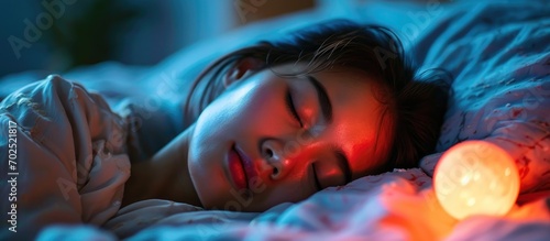 Asian woman in bed, sleeping peacefully with pleasant dreams.