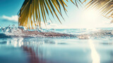 Sparkling sunlit water bubbles on the shore with a palm leaf frond against a tropical beach backdrop.