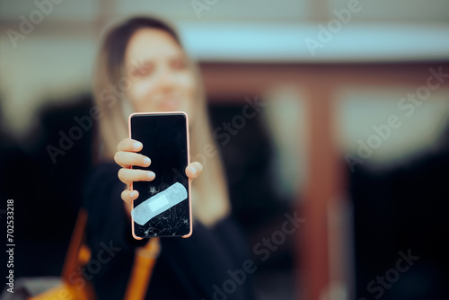 Billede på lærred Woman Fixing Broken Smartphone Display with a Bandage