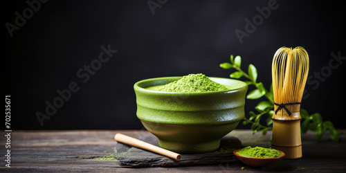 Ceramic bowl of bright green matcha tea next to a bamboo whisk on a dark wooden surface