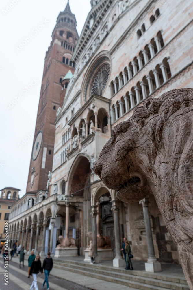View of the cathedral of <cremona from one of the 6 column-bearing lions present among the sculptures supporting the columns.