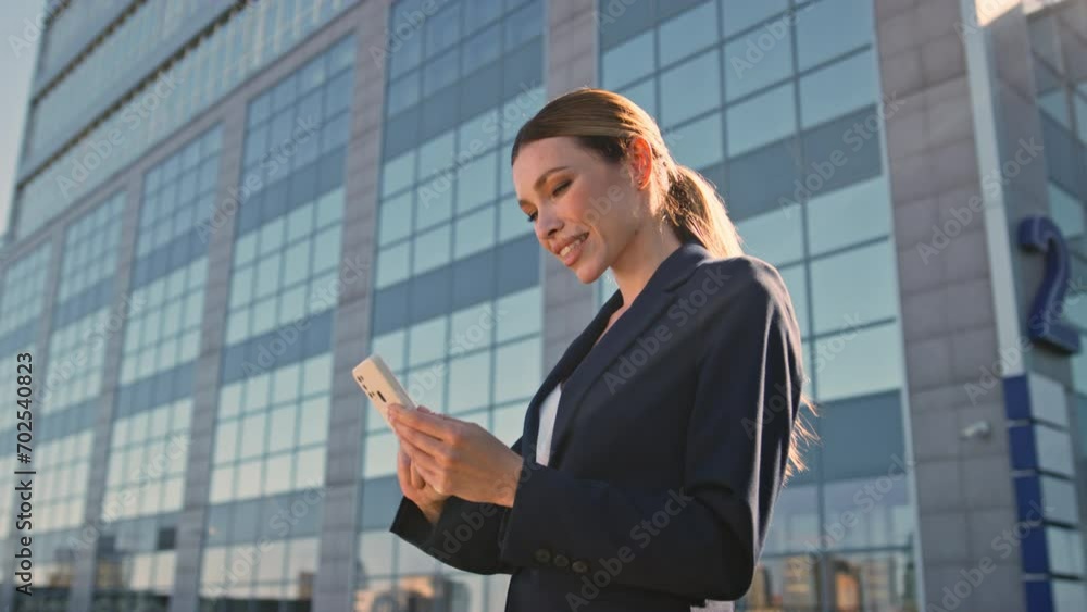 Business lady reading sms on telephone outdoors after office work day close up. Business lady reading sms on telephone outdoors after office work day close up.