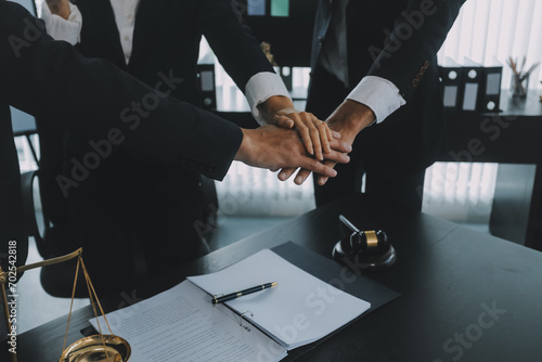 Group of experienced attorneys and lawyers giving consultation to client, helping with difficult lawsuit, explaining legal procedures and discussing agreement terms. Law services and support concept photo