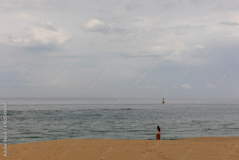Sand, sea, clouds and woman