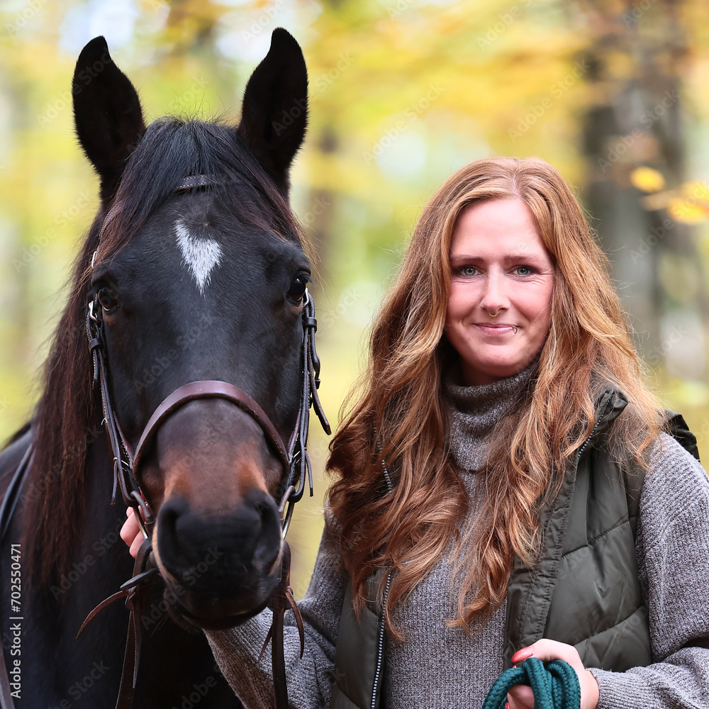 Fototapeta premium Woman with red hair and black horse, head portraits format 1:1.