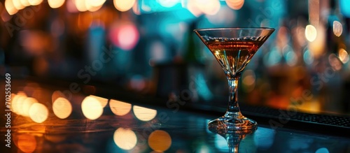 Alcoholic beverage in a retro cocktail glass on a glass table in a night club restaurant, close-up. photo