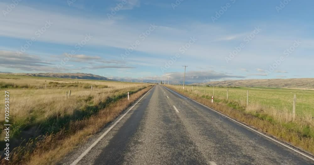 Scenic Drive On Straight Country Road In South Otago, New Zealand. POV, wide shot Scenic Drive On Straight Country Road In South Otago, New Zealand. POV, wide shot