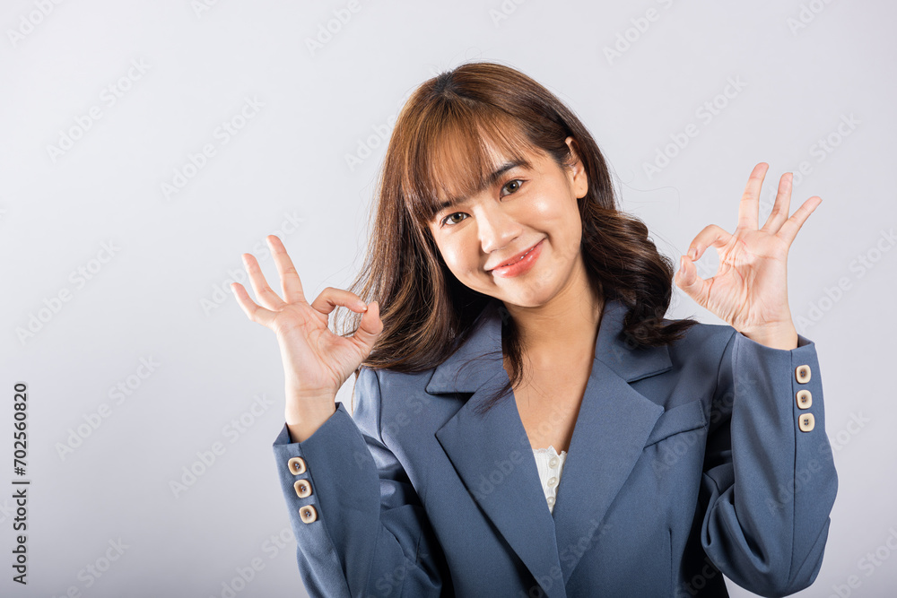 Asian teenage girl's vibrant spirit shines through in studio shot she confidently gestures the OK sign with fingers, radiating happiness against a white background, with room for your customized text. Asian teenage girl's vibrant spirit shines through in studio shot she confidently gestures the OK sign with fingers, radiating happiness against a white background, with room for your customized text.
