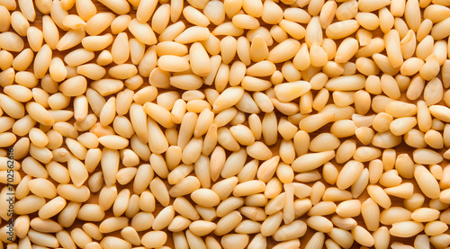 Pine Nuts Texture Close-Up: A dense texture of fresh pine nuts with a golden hue
