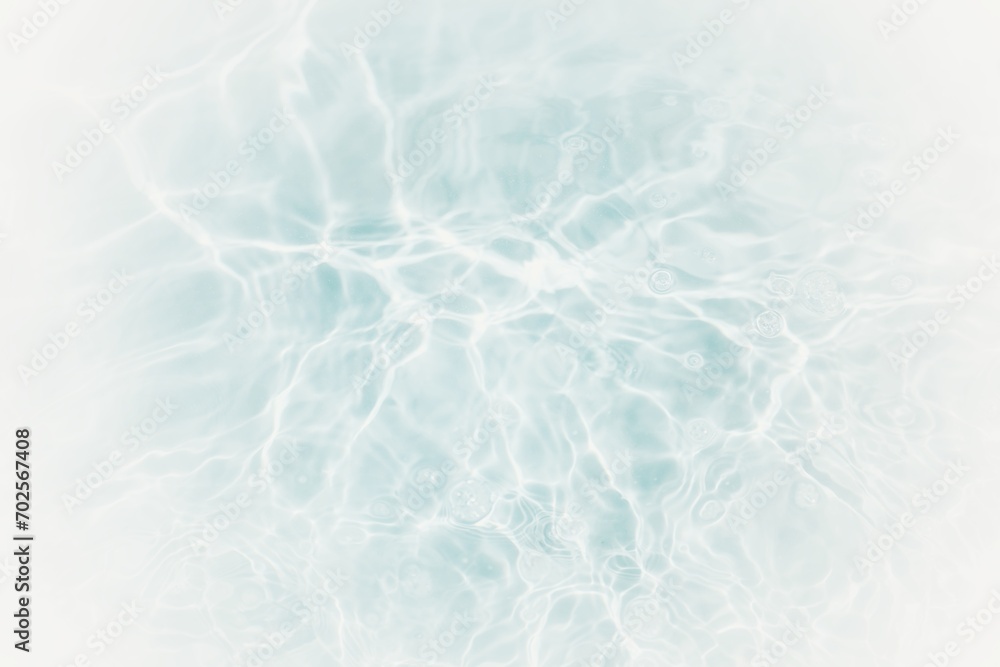 Obraz premium Bluewater waves on the surface ripples blurred. Defocus blurred transparent blue colored clear calm water surface texture with splash and bubbles. Water waves with shining pattern texture background.