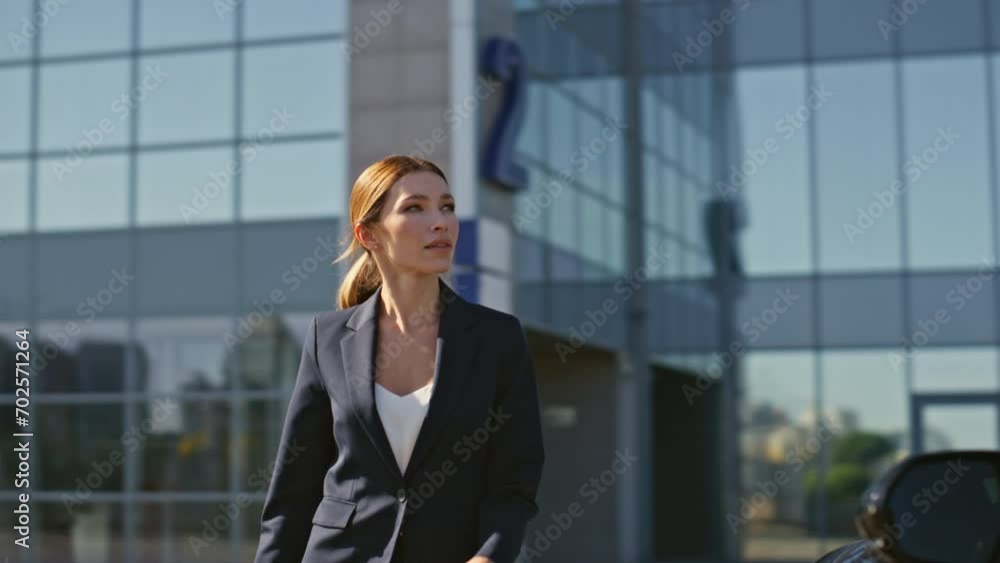Happy woman unlocking car using distance key at business district. Rich lady Happy woman unlocking car using distance key at business district. Rich lady