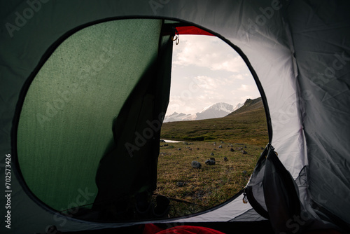 view from the tent to the snowy mountain peaks